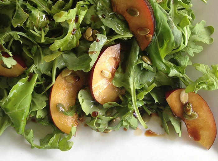 ARUGULA SALAD WITH PLUMS & PUMPKIN SEEDS
